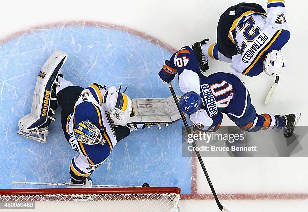 Jake Allen of the St. Louis Blues makes the first period save on Michael Grabner of the New York Islanders at the Nassau Veterans Memorial Coliseum...