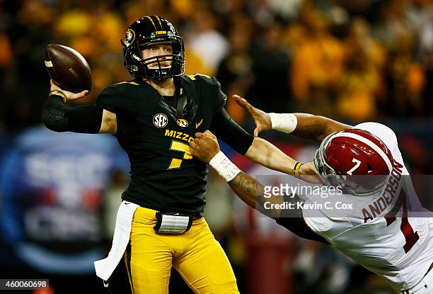 Maty Mauk of the Missouri Tigers passes under pressure from Ryan Anderson of the Alabama Crimson Tide in the first quarter of the SEC Championship...