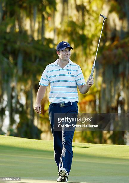 Jordan Spieth holes a long birdie putt on the 18th green to shoot a nine-under par 63 during the third round of the Hero World Challenge at the...