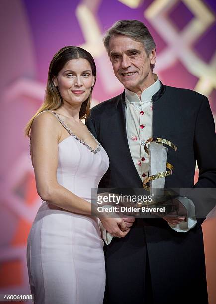 Jeremy Irons holding his award, poses with Laetitia Casta during te Tribute to Jeremy Irons as part of the 14th Marrakech International Film Festival...