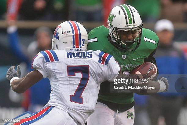 Xavier Woods of the Louisiana Tech Bulldogs tackles Tommy Shuler of the Marshall Thundering Herd during the third quarter at Joan C. Edwards Stadium...