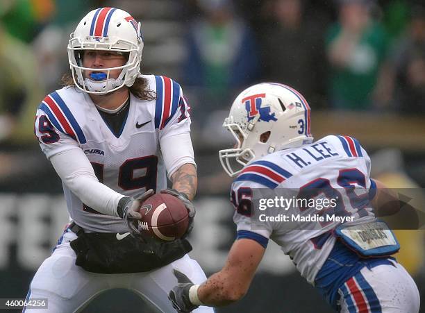 Cody Sokol of the Louisiana Tech Bulldogs hands the ball off to Hunter Lee during the third quarter against the Marshall Thundering Herd at Joan C....