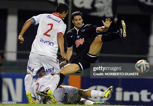 Libertad's player Herna Rodrigo Lopez vies for the ball with Gustavo Velazquez of Nacional during the Paraguayan Clausura tournament football final...