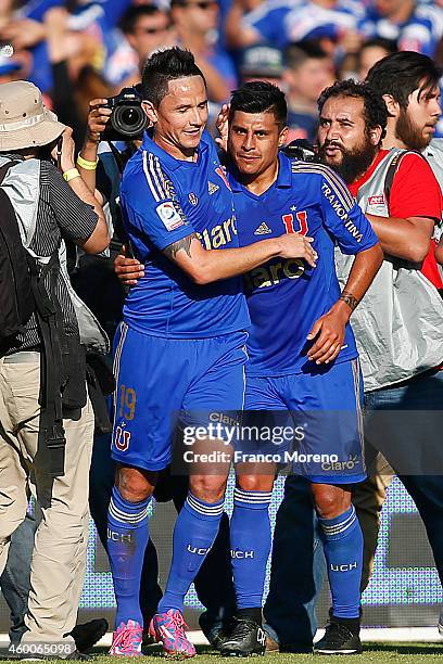 Gustavo Canales of U de Chile celebrates with teammate Patricio Rubio after scoring the winning goal during a match between Universidad de Chile and...