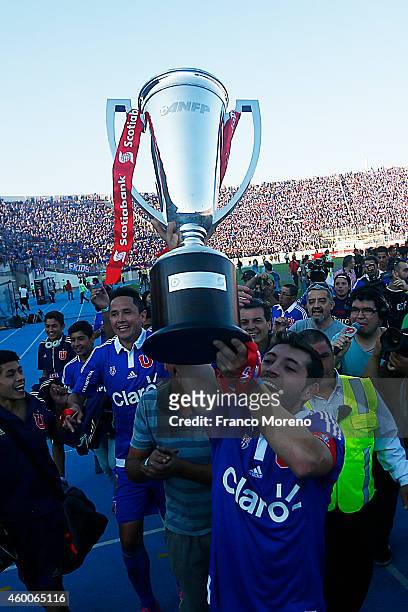 Jose Rojas of U de Chile lifts the trophy and celebrate with teamates the championship after a match between Universidad de Chile and La Calera as a...