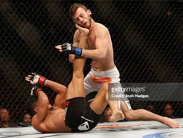 Alex White kicks Clay Collard in their bantamweight bout during the UFC 181 event inside the Mandalay Bay Events Center on December 6, 2014 in Las...