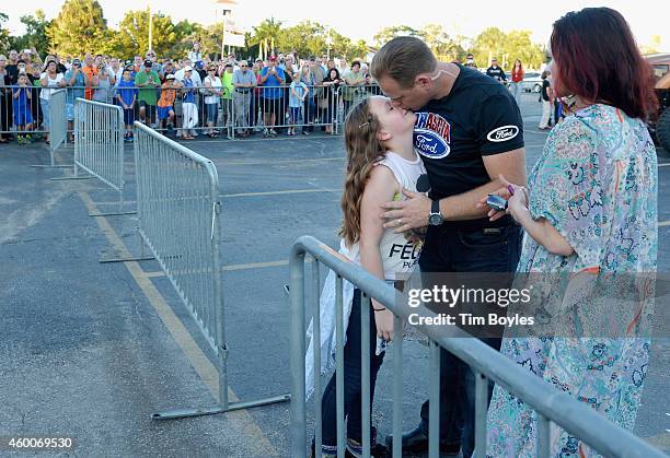 Nik Wallenda kisses his daughter Evita while his wife Erendira looks on before walking a high wire over Sarasota Ford on December 6, 2014 in...