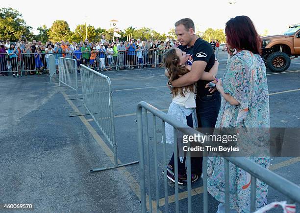 Nik Wallenda hugs his daughter Evita while his wife Erendira looks on before walking a high wire over Sarasota Ford on December 6, 2014 in Sarasota,...