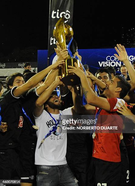Libertad's players celebrate with the trophy after winning Paraguay's Clausura tournament final football match against Nacional, in Asuncion, on...
