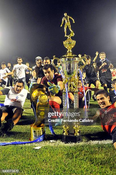 Players of Libertad celebrate their championship after a match between Nacional and Libertad as part of round 22 of Torneo Clausura 2014 at Manuel...