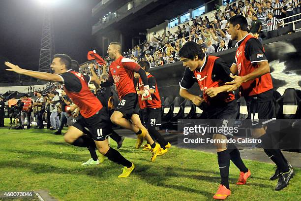 Players of Libertad run out the bench to celebrate the championship after a match between Nacional and Libertad as part of round 22 of Torneo...