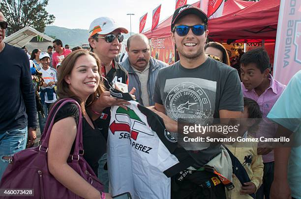 Mexican driver of Formula one Sergio "Checo" Pérez signs autographs prior a race in the Grand Prix International Wings Army kart at Omnilife Stadium...