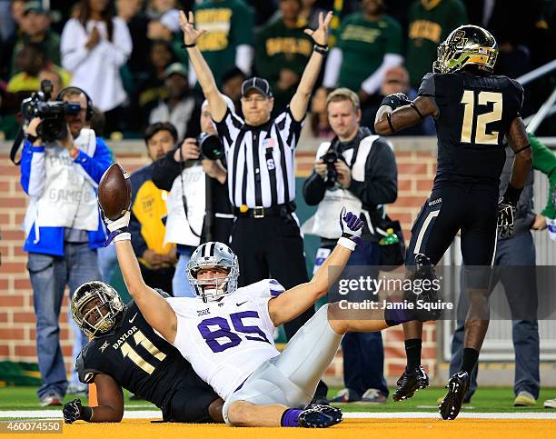 Zach Trujillo of the Kansas State Wildcats scores a touchdown as Taylor Young of the Baylor Bears and Alfred Pullom of the Baylor Bears defend during...