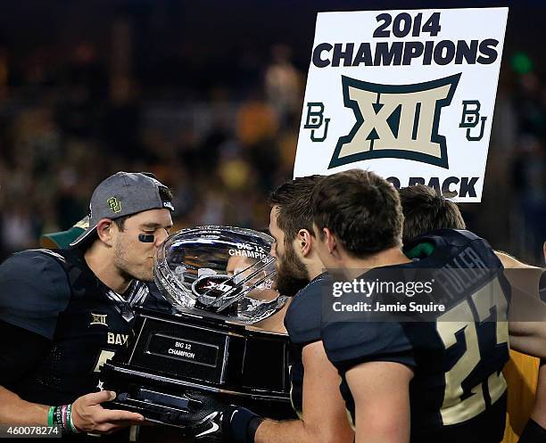 Bryce Petty of the Baylor Bears kisses the Big 12 Championship trophy following their win over Kansas State Wildcats on December 6, 2014 at McLane...