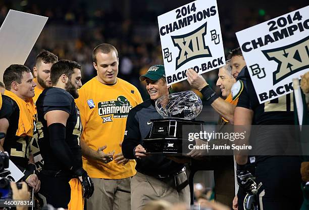 Baylor Bears head coach Art Briles holds the Big 12 Championship trophy following their win over Kansas State Wildcats on December 6, 2014 at McLane...