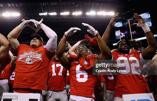 Evan Spencer , Adolphus Washington and the Ohio State Buckeyes celebrate after they defeated the Wisconsin Badgers 59-0 in the Big Ten Championship...