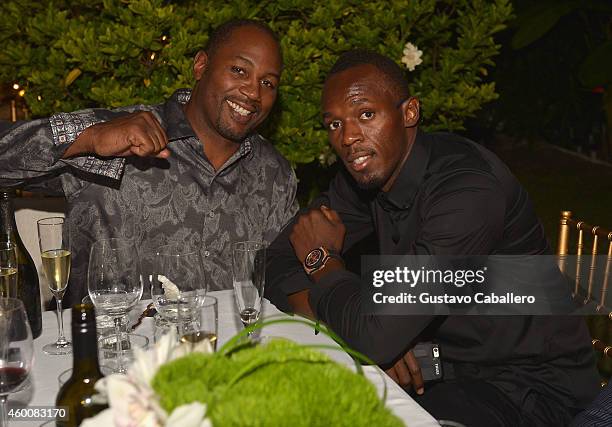 Lennox Lewis and Usain Bolt attend Haute Living 10th Year Anniversary Party on December 6, 2014 in Miami, Florida.