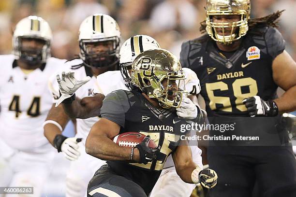 Lache Seastrunk of the Baylor Bears is face-masked by Terrance Plummer of the UCF Knights during the Tostitos Fiesta Bowl at University of Phoenix...