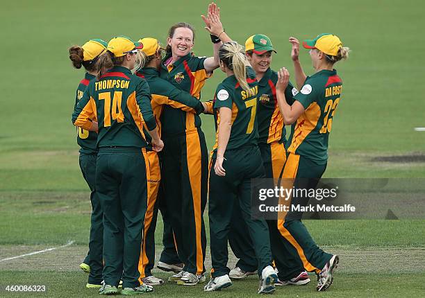 Veronica Pyke of the Roar celebrates with team mates after bowling Beth Morgan of the Scorpions during the WT20 match between the Tasmanian Roar and...