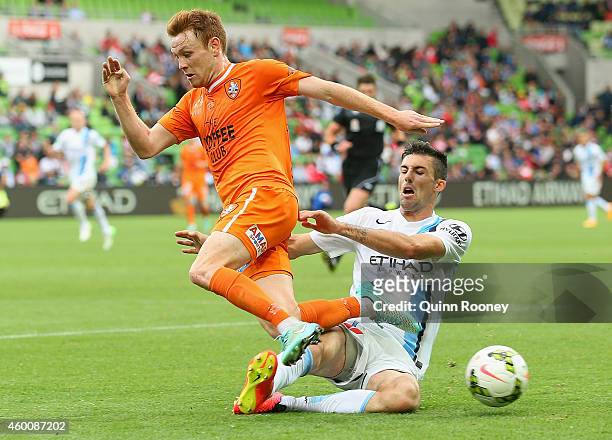 Corey Brown of the Roar is tackled by Jason Hoffman of City during the round 10 A-League match between Melbourne City FC and Brisbane Roar at AAMI...