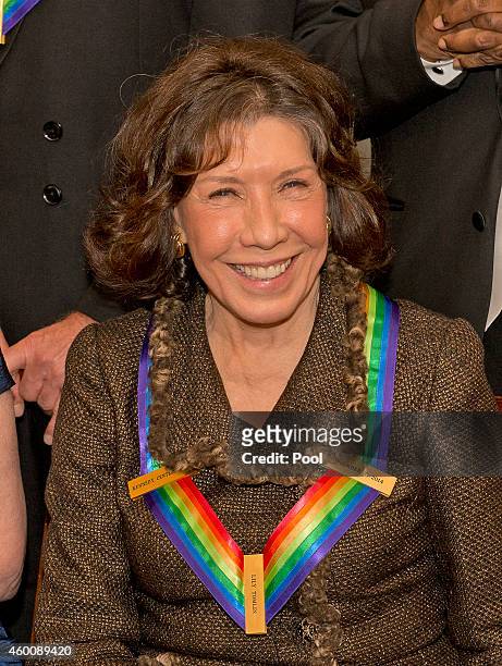 Comedienne Lily Tomlin, one of the five recipients of the 2014 Kennedy Center Honors, waits to pose for a group photo following a dinner hosted by...