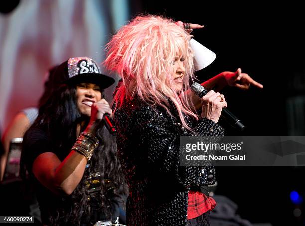 Salt-N-Pepa and Cyndi Lauper perform during the 4th Annual "Home For The Holidays" Benefit Concert at Beacon Theatre on December 6, 2014 in New York...