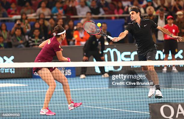 Roger Federer and Sania Mirza of the Indian Aces in action against Nick Kyrgios and Daniela Hantuchova of the Singapore Slammers during the Coca-Cola...