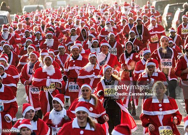 Participants dressed as Santa Claus gather for the annual Santa Run on December 7, 2014 in Michendorf, Germany. At least 800 adults and children...