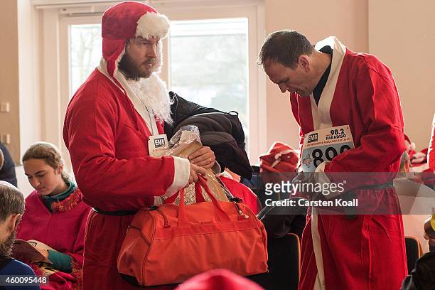 Participants dressed as Santa Claus prepare to attend the annual Santa Run on December 7, 2014 in Michendorf, Germany. At least 800 adults and...