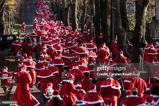 Participants dressed as Santa Claus gather for the annual Santa Run on December 7, 2014 in Michendorf, Germany. At least 800 adults and children...