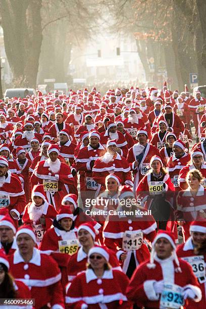 Participants dressed as Santa Claus gather for the annual Santa Run on December 7, 2014 in Michendorf, Germany. At least 800 adults and children...