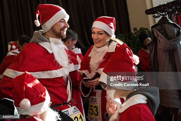 Participants dressed as Santa Claus prepare to attend the annual Santa Run on December 7, 2014 in Michendorf, Germany. At least 800 adults and...