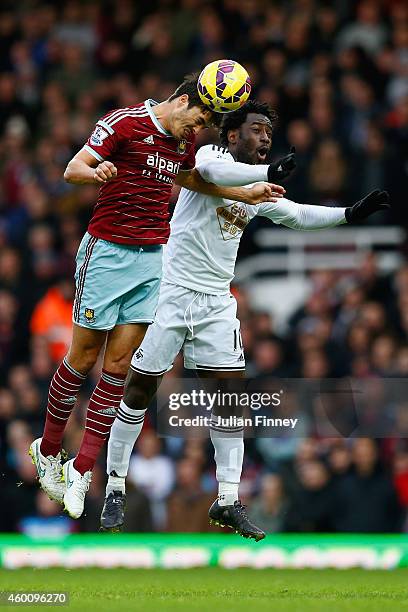 James Tomkins of West Ham and Wilfried Bony of Swansea City compete for the header during the Barclays Premier League match between West Ham United...