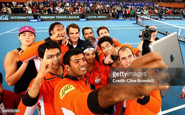 Rohan Bopanna of the Indian Aces taks a group selfie after Roger Federers victory in his match against Tomas Berdych of the Singapore Slammers during...