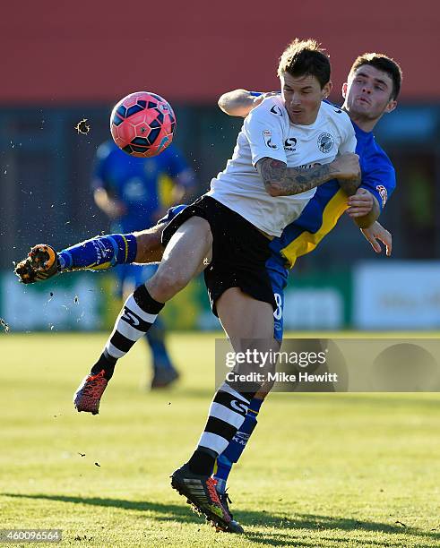 John Oster of Gateshead is challenged by Nathan Burke of Warrington during the FA Cup Second Round tie between Gateshead FC v and Warrington Town at...