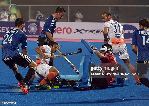 Indian hockey player Dharamvir Singh attempts a goal as Argentina's goalkeeper Augastin Abratte tries to block him during their Hero Hockey Champions...