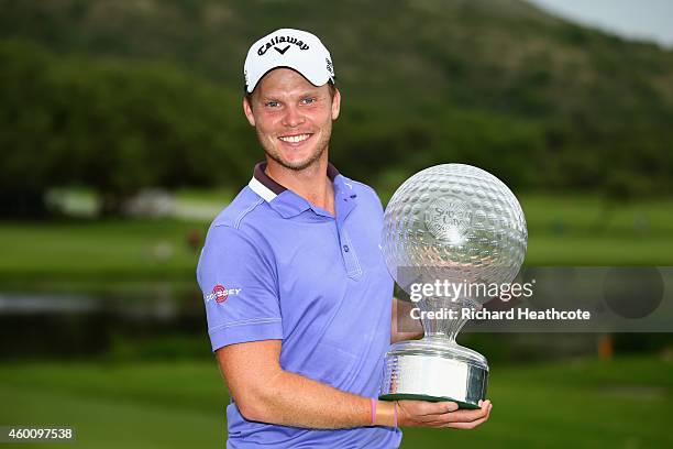 Danny Willett of England poses with the trophy after securing victory during the final round of the Nedbank Golf Challenge at the Gary Player Country...
