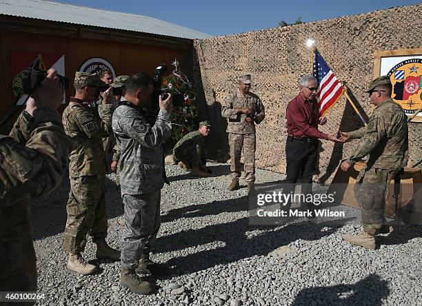 Secretary of Defense Chuck Hagel greets American troops during a visit, December 7, 2014 in FOB Gamberi, Afghanistan. Secretary Hagel visited the...