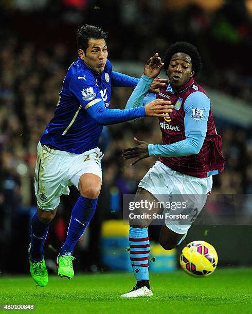 Leonardo Ulloa of Leicester is challenged by Carlos Sanchez of Villa during the Barclays Premier League match between Aston Villa and Leicester City...