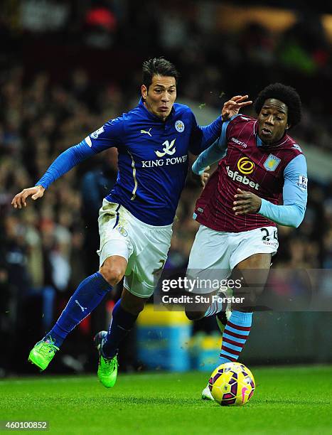 Leonardo Ulloa of Leicester is challenged by Carlos Sanchez of Villa during the Barclays Premier League match between Aston Villa and Leicester City...