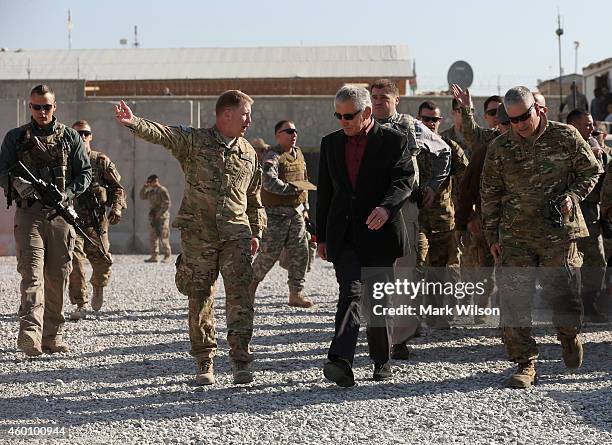 Secretary of Defense Chuck Hagel is showed the way by US Army Brigadier General Christopher F. Bentley after arriving, December 7, 2014 in FOB...