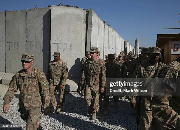 Members of the U.S. Military head to a area to meet with U.S. Secretary of Defense Chuck Hagel, December 7, 2014 in FOB Gamberi, Afghanistan....