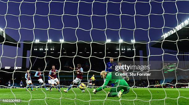 Leonardo Ulloa of Leicester scores the first goal past Villa goalkeeper Brad Guzan during the Barclays Premier League match between Aston Villa and...