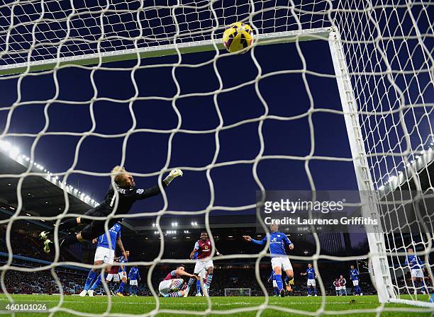 Ciaran Clark of Aston Villa scores their first goal past Kasper Schmeichel of Leicester City during the Barclays Premier League match between Aston...
