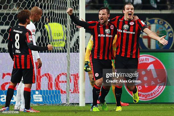 Alexander Meier of Frankfurt celebrates his team's first goal with team mates Haris Seferovic and Takashi Inui during the Bundesliga match between...