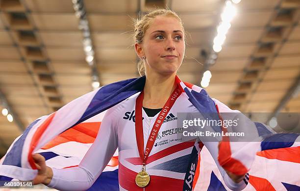 Laura Trott of Great Britain poses with her gold medal and a Union Jack flag after winning the Women's Omnium on day three of the UCI Track Cycling...