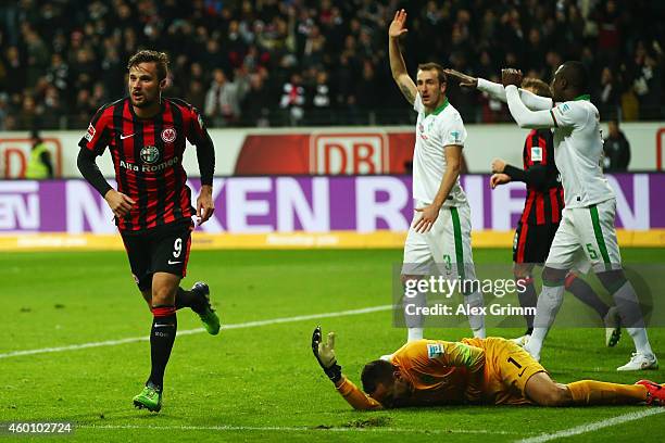 Haris Seferovic of Frankfurt celebrates his team's second goal as goalkeeper Raphael Wolf of Bremen lies on the ground during the Bundesliga match...