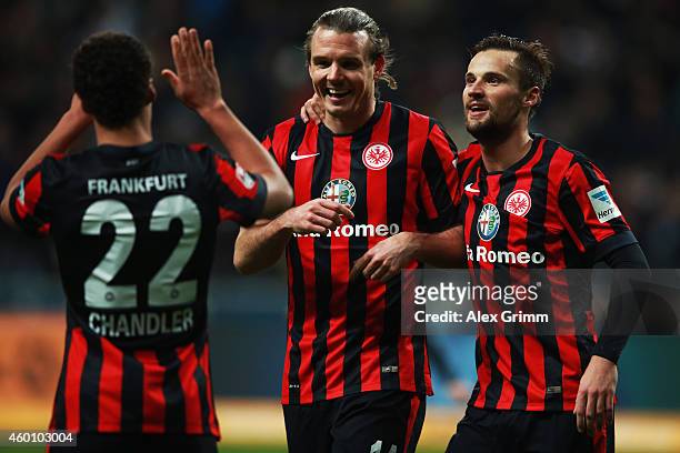 Alexander Meier of Frankfurt celebrates his team's third goal with team mate Haris Seferovic and Timothy Chandler during the Bundesliga match between...