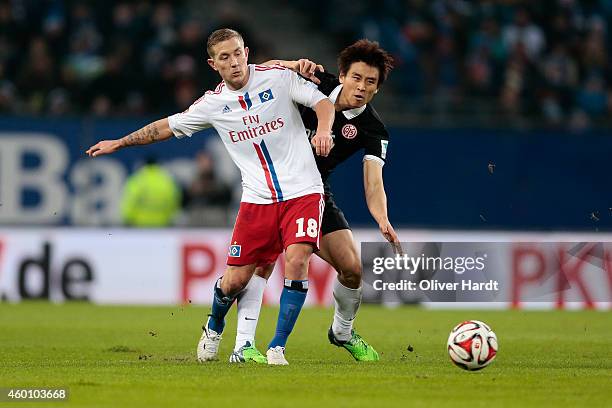 Lewis Holtby of Hamburg and Ja Cheol Koo of Mainz compete during the First Bundesliga match between Hamburger SV and 1. FSV Mainz 05 at Imtech Arena...