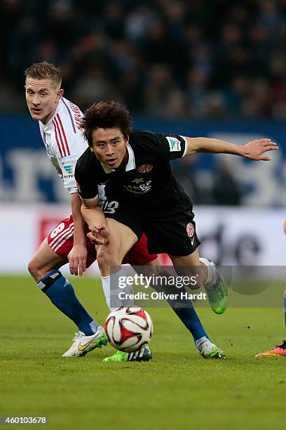 Lewis Holtby of Hamburg and Ja Cheol Koo of Mainz compete during the First Bundesliga match between Hamburger SV and 1. FSV Mainz 05 at Imtech Arena...